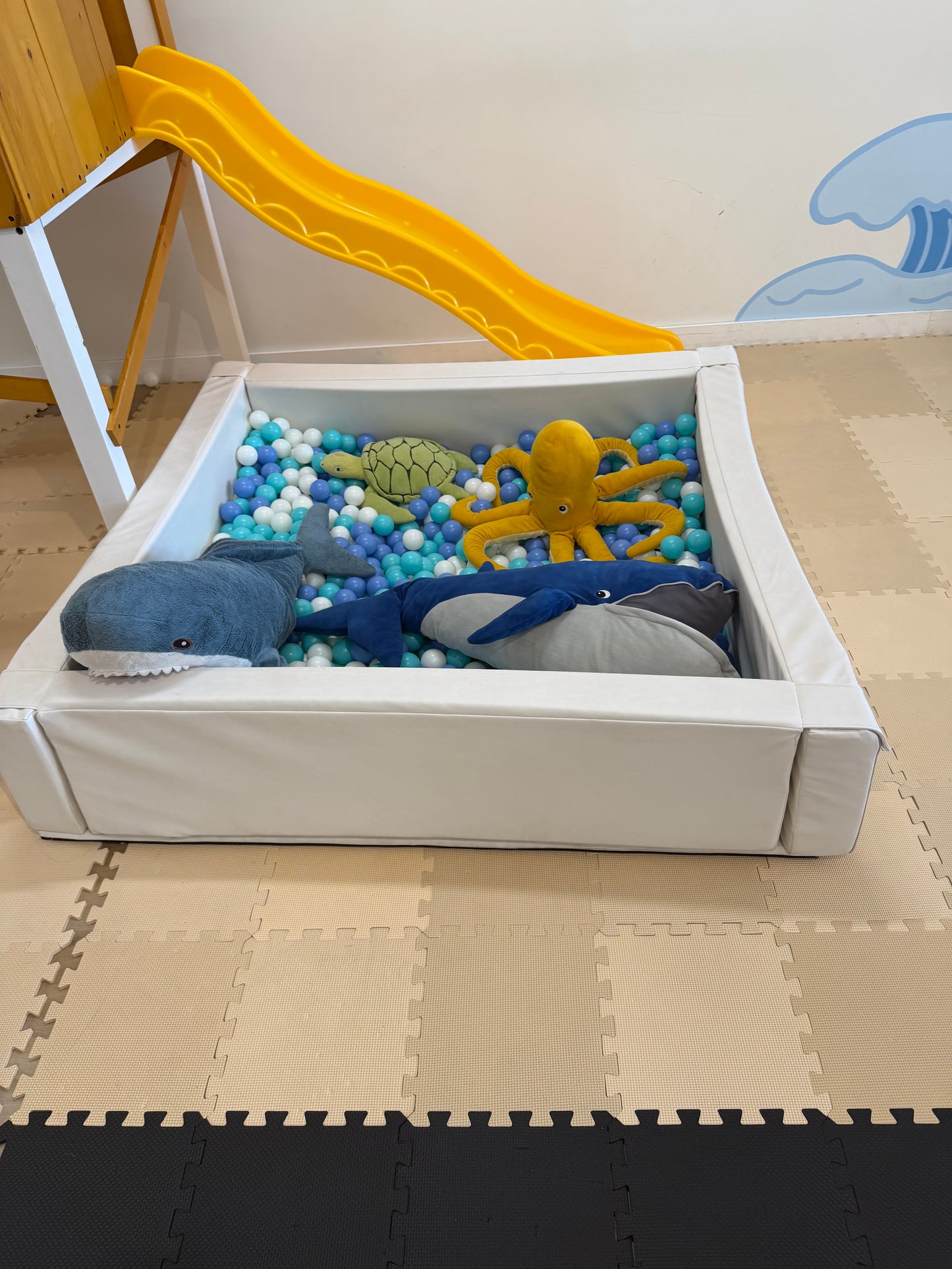Ball pit with balls and stuffed animals