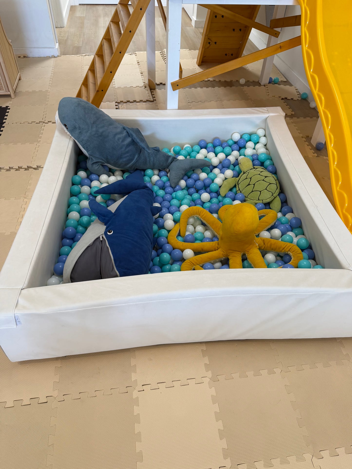 Ball pit with balls and stuffed animals